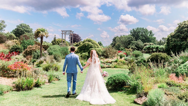 A couple on their wedding day dressed in bridal clothing